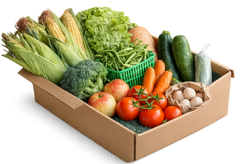 Assorted fresh vegetables and fruits in a cardboard box on a white background